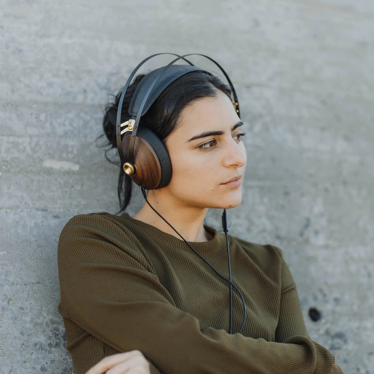 Woman listening to the premium audiophile closed back headphones from Meze Audio