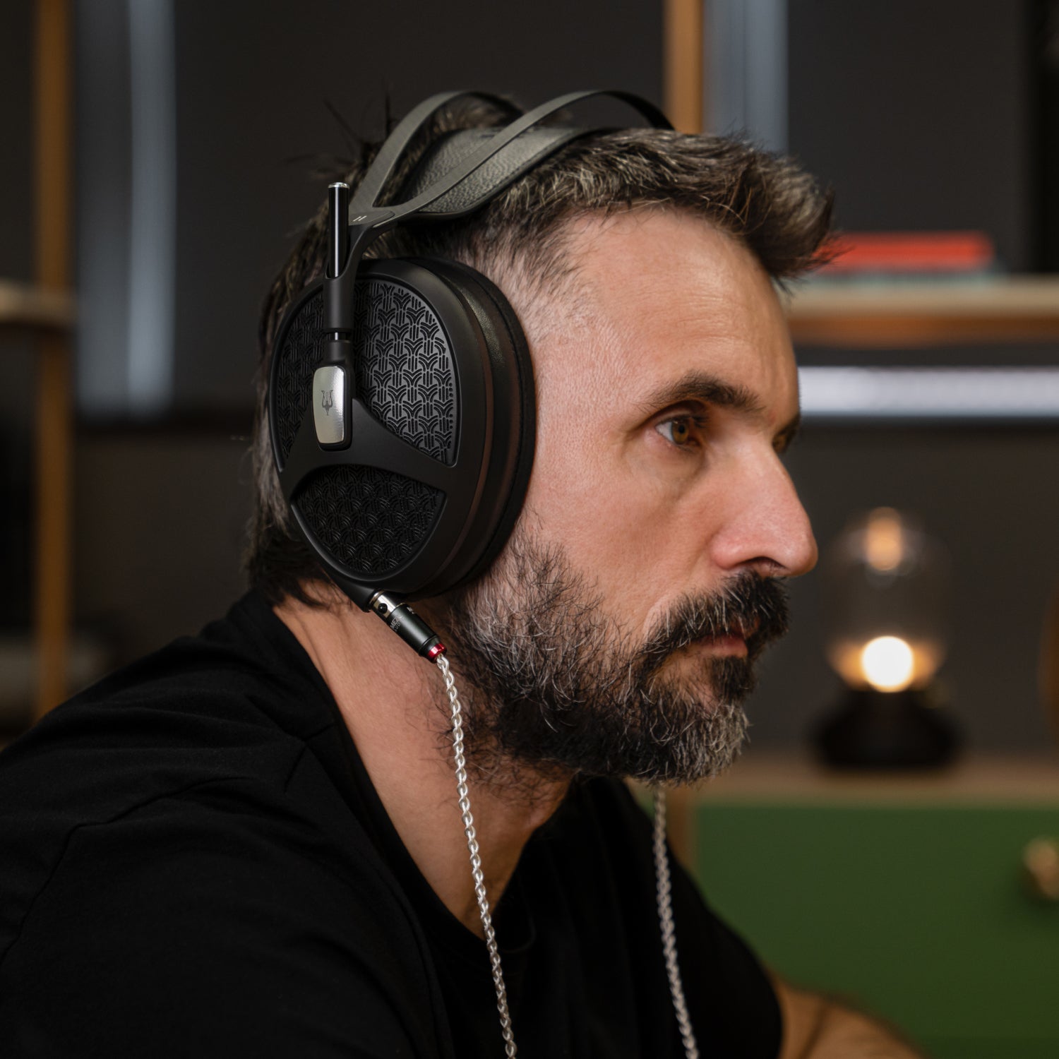 Man listening to music on the premium open-back headphones Meze Audio Empyrean II