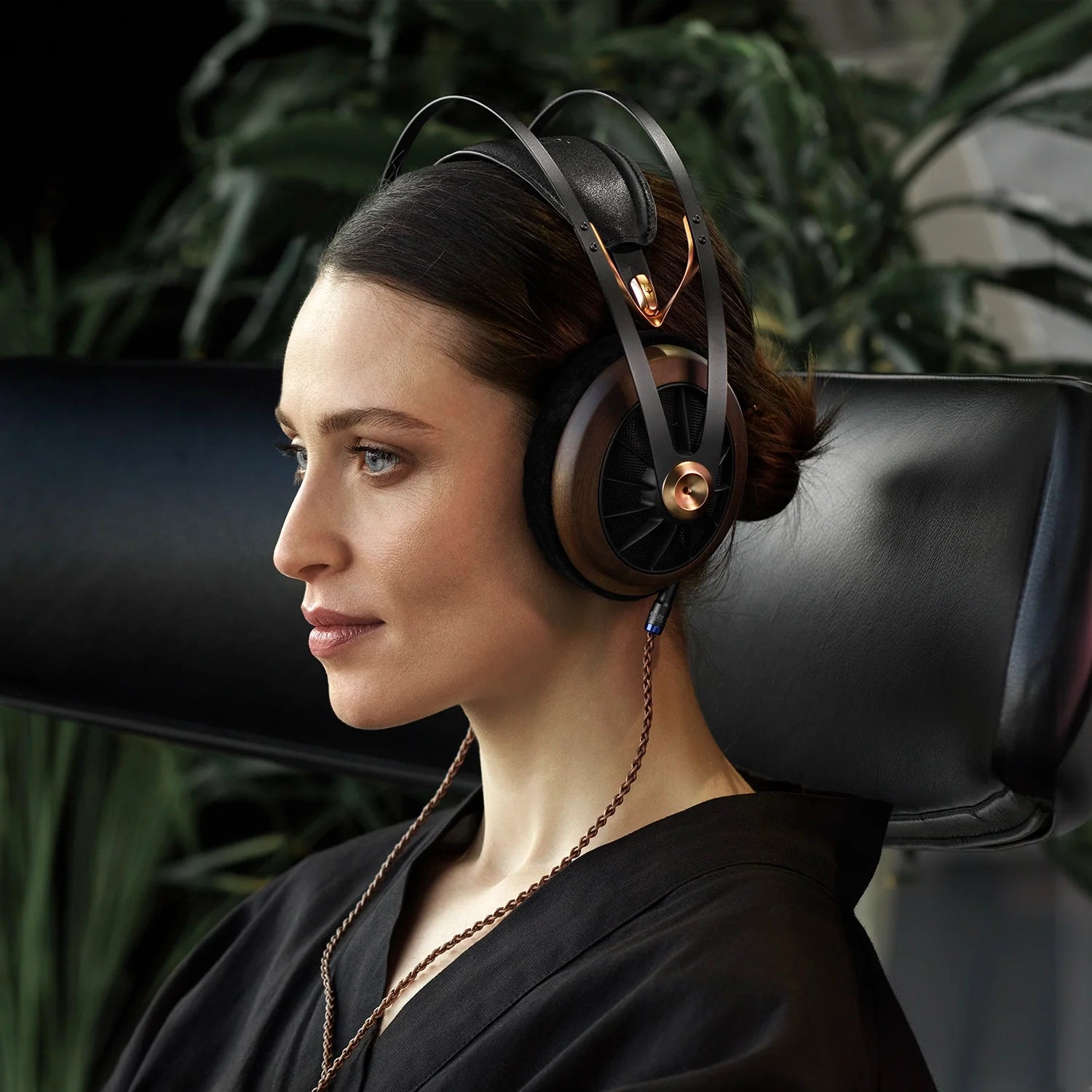 Woman using the Meze Audio 109 PRO premium audiophile open-back headphone connected to the Meze Audio Mono 3.5 mm PCUHD Premium Copper Cable